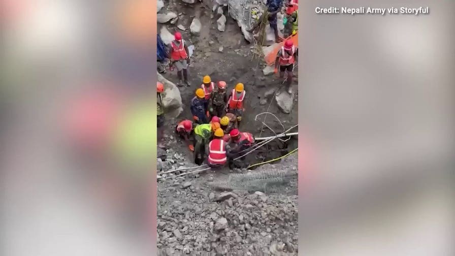 Rescue crews in Nepal save two men trapped in tunnels for nine days following floods
