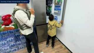 Gazan boy found alive plays with GHF representative