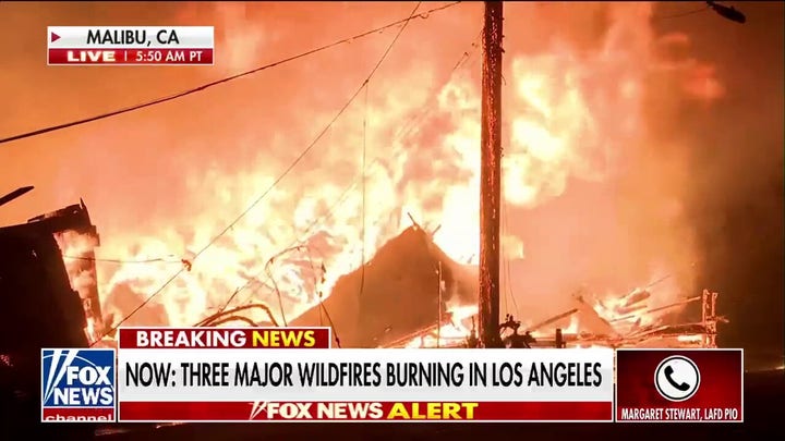 LA fire official says high winds hindering firefighting efforts from air 