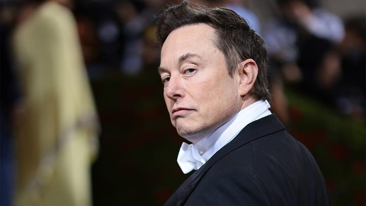 Elon Musk captured looking at the camera during an event.
