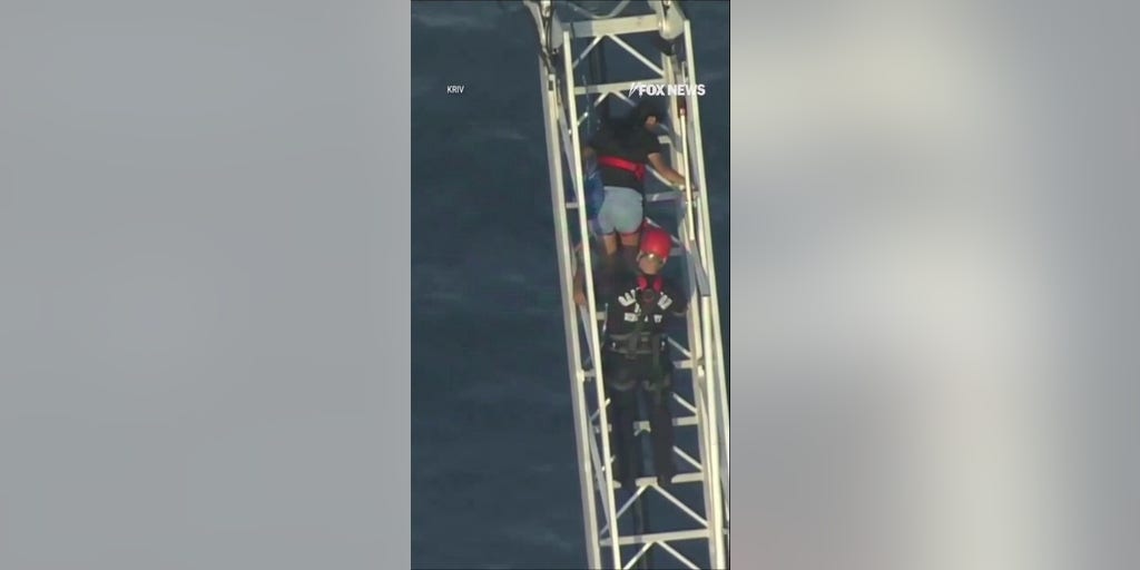 Roller coaster riders rescued after ride STALLS 100 feet above ground