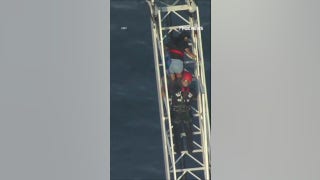 Roller coaster riders rescued after ride STALLS 100 feet above ground