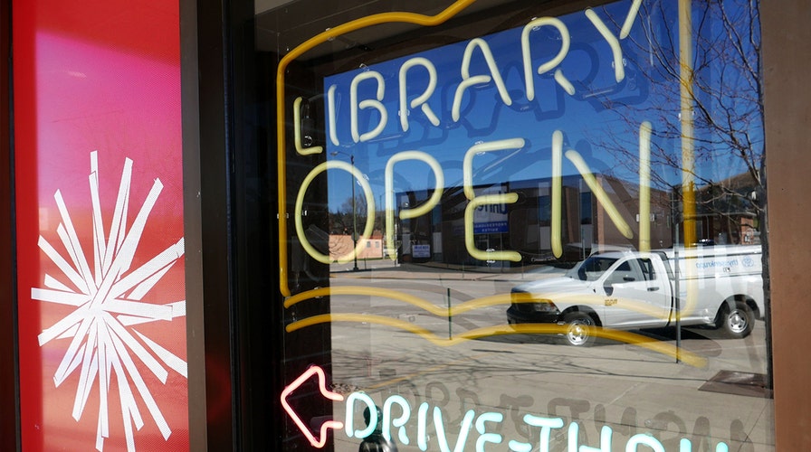 Coronavirus mandates may close library doors, but this center is still serving its community, through a window