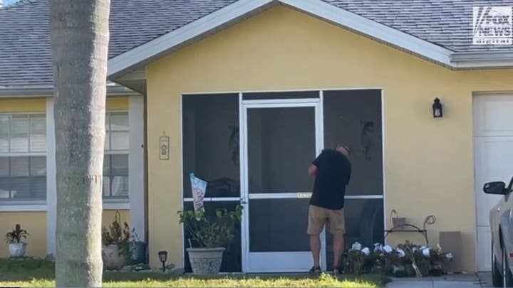 Chris Laundrie spotted installing what appears to be video doorbell and picking up mail at his Florida home