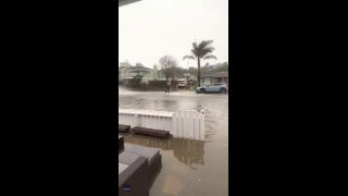 California man seen surfing behind a car after massive neighborhood flooding - Fox News