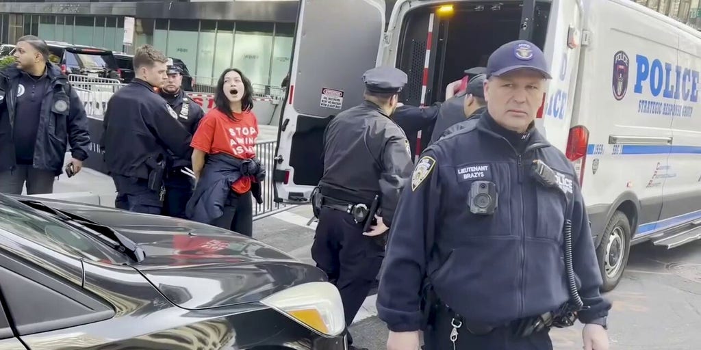 Police haul away protesters outside Trump Tower