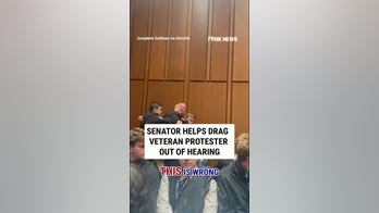 Senator helps DRAG veteran protester out of hearing