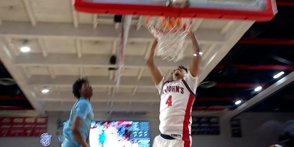 Oziyah Sellers drives through two defenders for a dunk, extending St. Johns lead over Quinnipiac