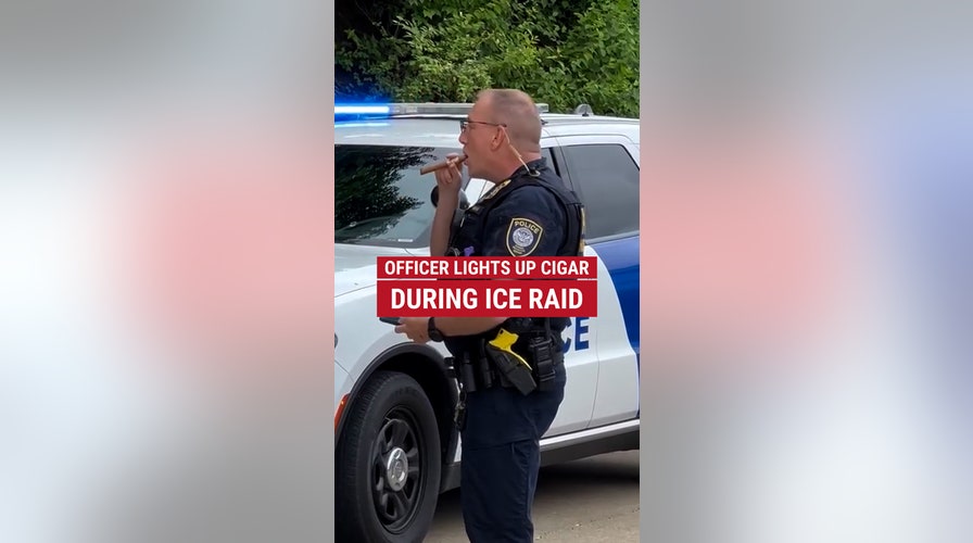 A DHS officer was spotted smoking a cigar during an ICE raid
