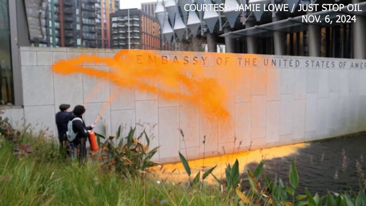 Climate activists protest Trump win, spray orange paint on US