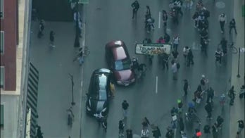 Car drives through anti-ICE protesters in Downtown Chicago
