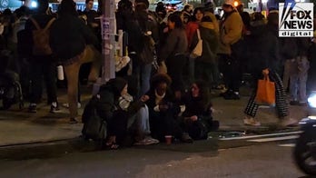 Congresswoman's daughter, Isra Hirsi, sits outside NYPD headquarters following her arrest, release