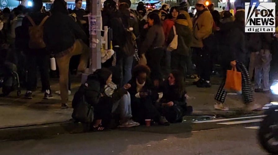 Congresswomans daughter, Isra Hirsi, sits outside NYPD headquarters following her arrest, release