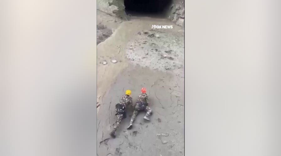 Rescuers crawl through mud to save workers trapped in Nepal tunnel