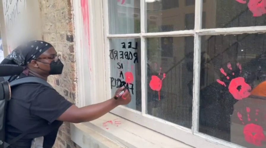 An anti-Israel protesters vandalize the UNC Chapel Hill chancellor's office.
