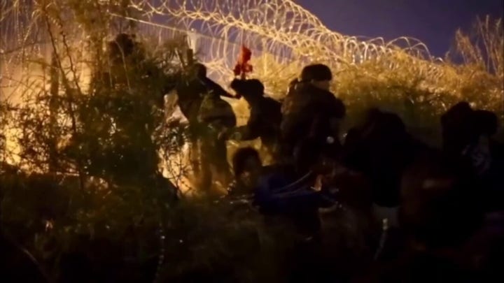 Hundreds of migrants cross into US after cutting opening in razor wire