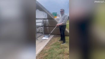 Cruz paints over “F--- Charlie Kirk” graffiti near Houston highway bridge