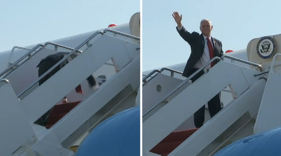 Pence stumbles climbing stairs to Air Force Two