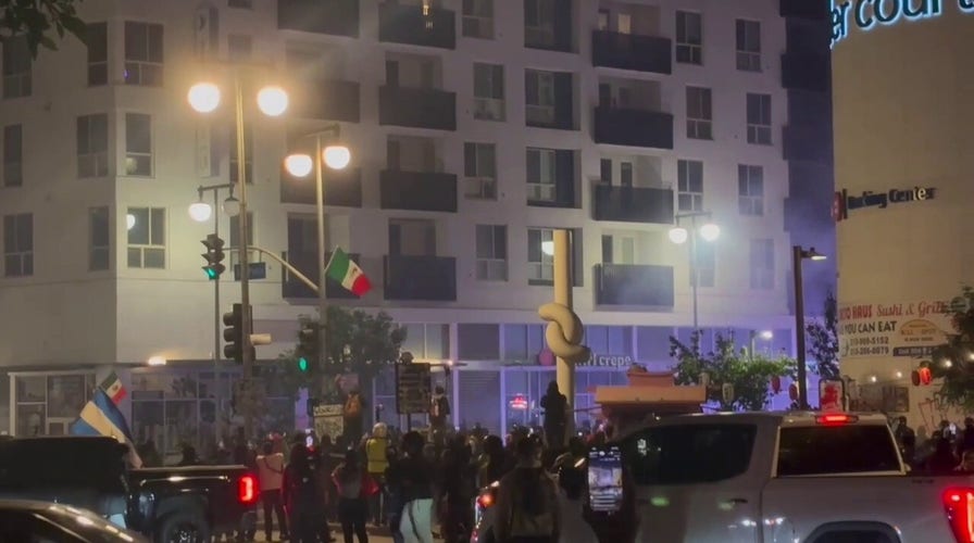 Protesters flee downtown Los Angeles street corner after police deploy tear gas