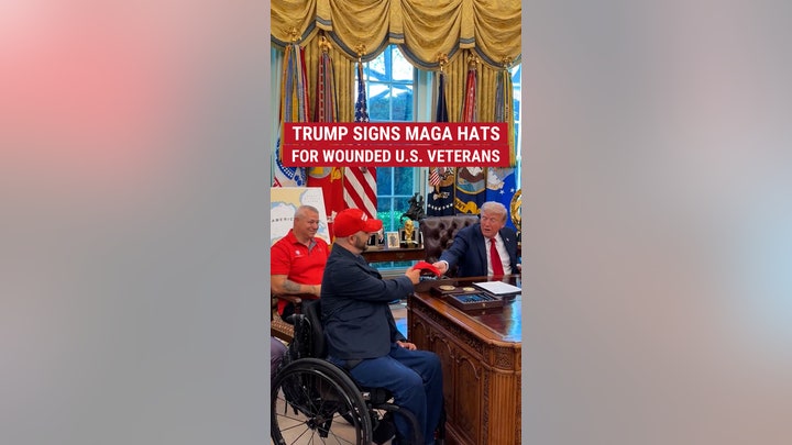 Trump signs MAGA hats for wounded U.S. veterans. 