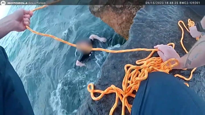 Stunning water rescue: Officers go all out to save young woman who had slipped into water off Lake Michigan