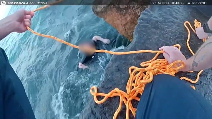 Stunning water rescue: Officers go all out to save young woman who slips into water off Lake Michigan