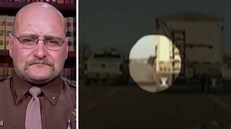Cop jumps into moving truck to save driver