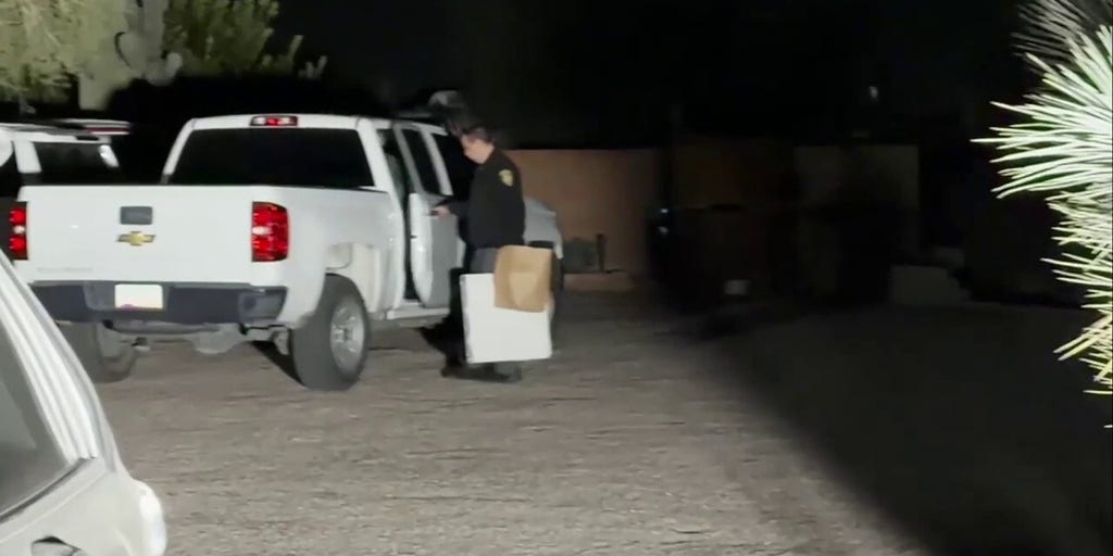 Officer seen leaving Annie Guthrie's home with white case and brown bag