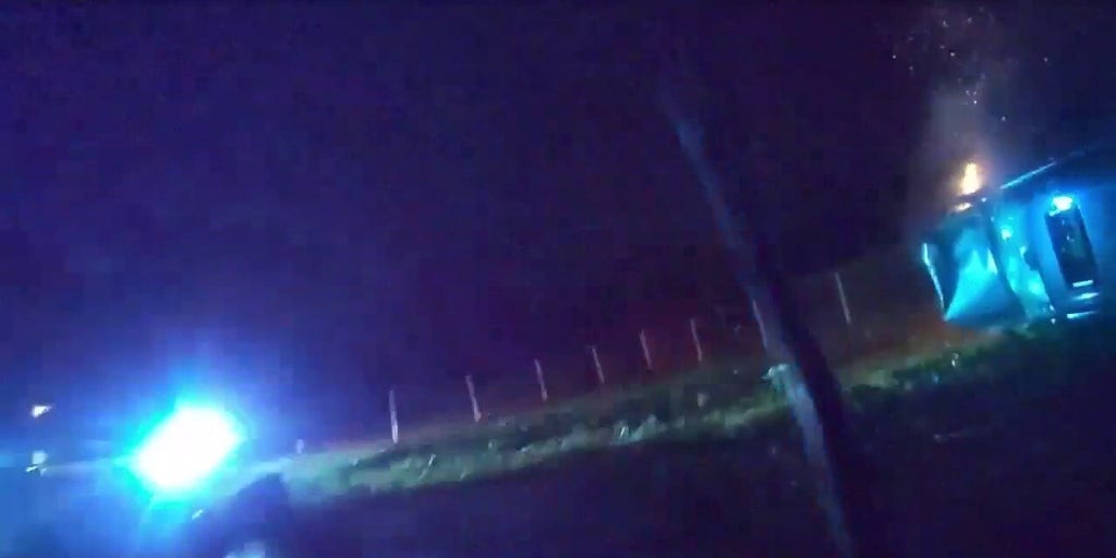 Hero officers race in to save trapped driver from fiery car crash in dramatic rescue