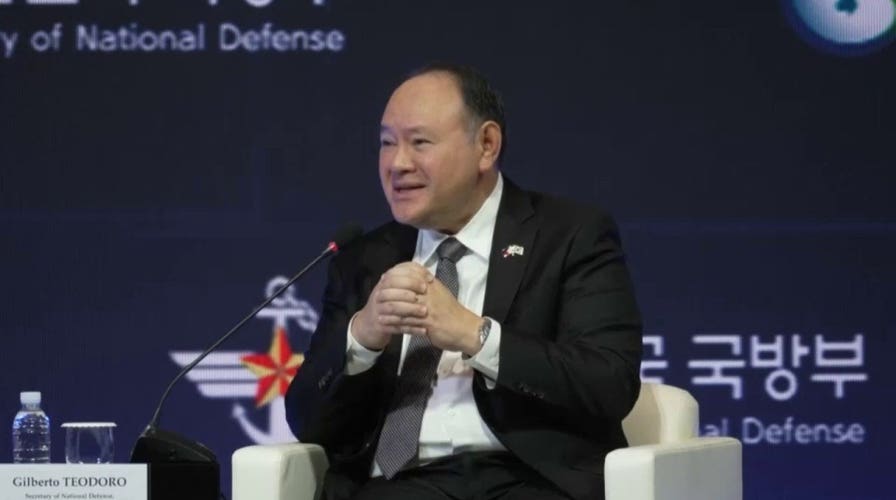 Philippines defense chief unloads on China after being handed note on stage