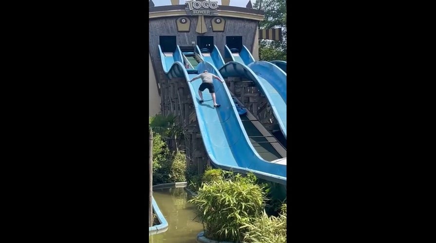 British father rescues daughter stuck on water slide 