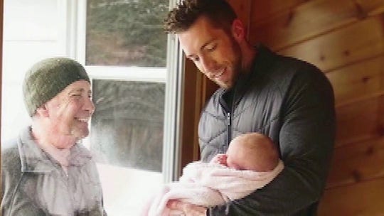 Michigan grandfather walks miles to see new granddaughter through glass door