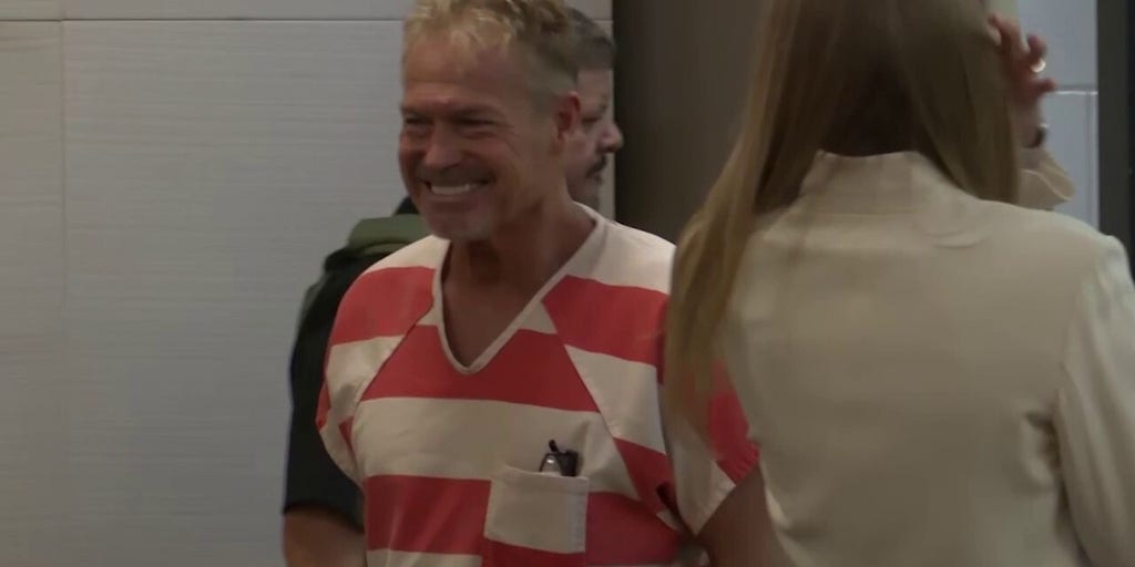 Barry Morphew smiles as he enters court