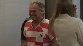 Barry Morphew smiles as he enters court