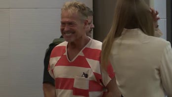 Barry Morphew smiles as he enters court