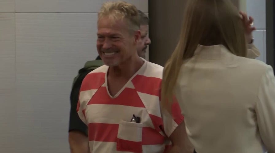 Barry Morphew smiles as he enters court