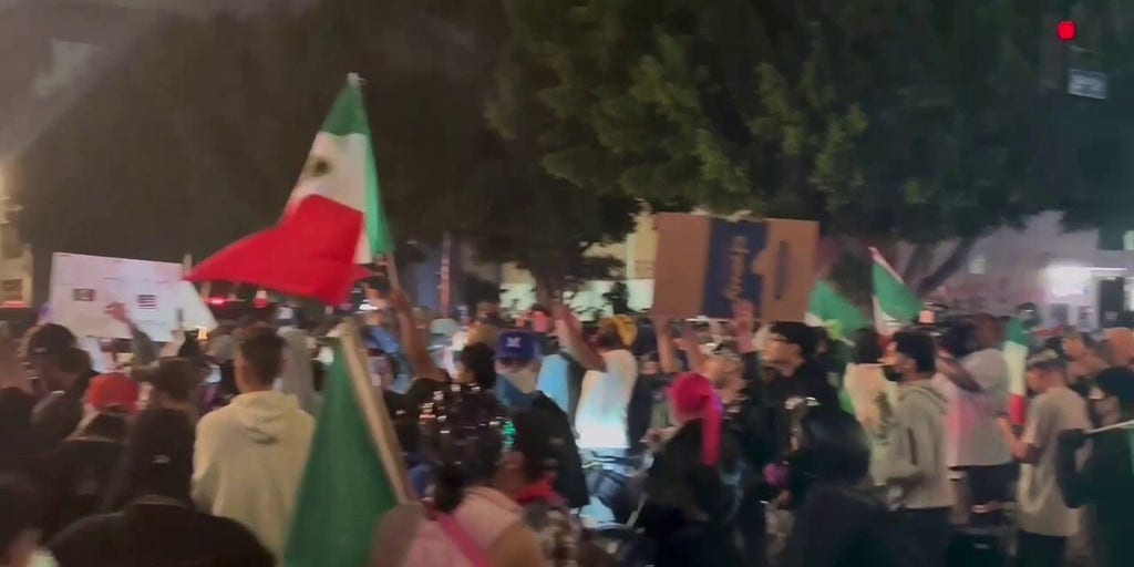 Protestors with Mexican flags shut down street corner in downtown Los Angeles