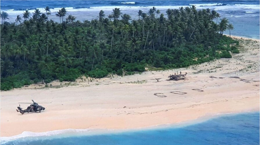 Men rescued from Pacific island after writing SOS sign in the sand