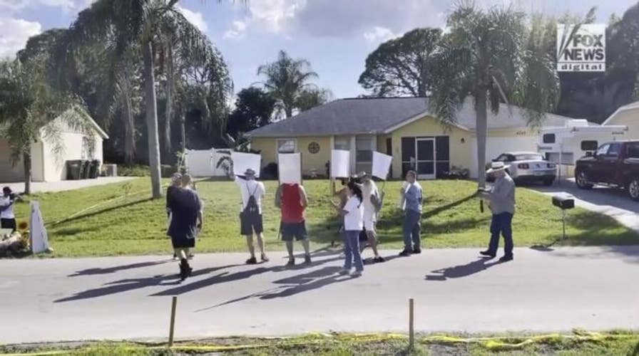Protesters outside home of Brian Laundrie's parents hold up signs and chant 'Justice for Gabby'