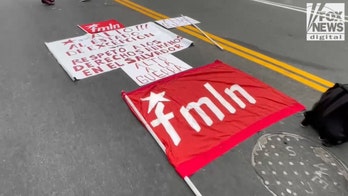Activist banners laid out, ready for May Day march in LA