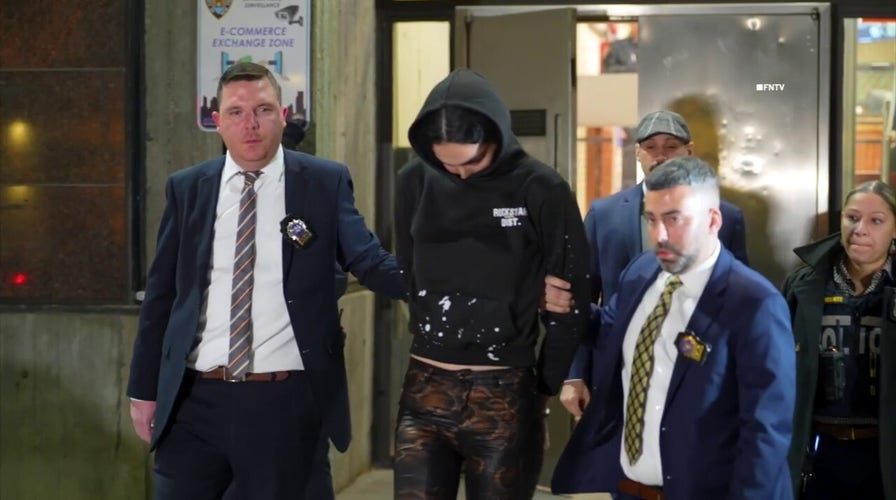 Trans suspect in mailman's stabbing murder escorted out of NYPD precinct