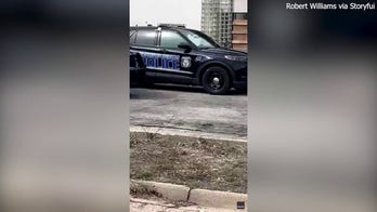 Handcuffed woman wriggles free from police cruiser, takes off on foot