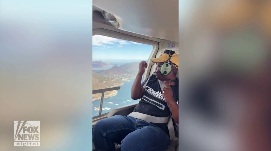 Travelers thank their security guard with a helicopter ride over South African town