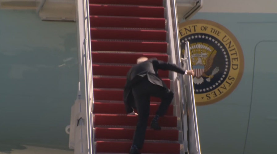 Biden stumbles while walking up steps to Air Force One