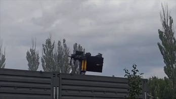 Russian soldier sent flying as Soviet-era helicopter gun spins out of control