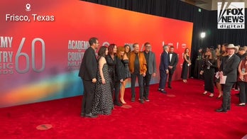 Reba McEntire poses for photos on the ACM Awards red carpet