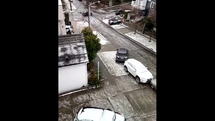 Watch as cars slide down street and collide with one another in Seattle