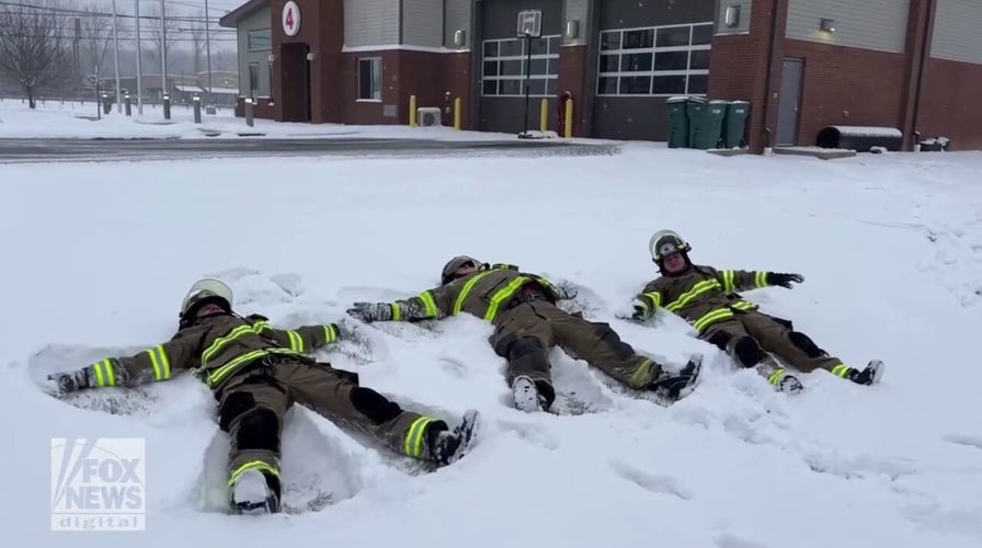 Firefighters take a break to make snow angels during winter storm