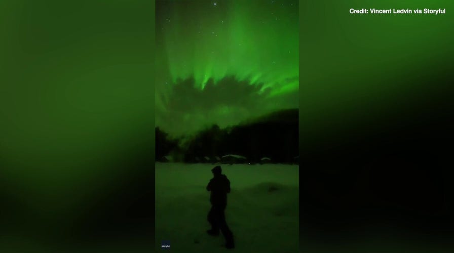 Watch as boiling water instantly freezes under bright green aurora in Alaska