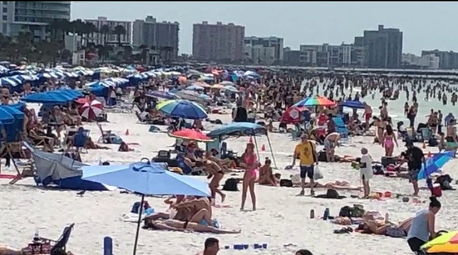 Spring breakers crowd Florida beach despite calls for social distancing